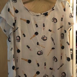 White blouse with a makeup print
